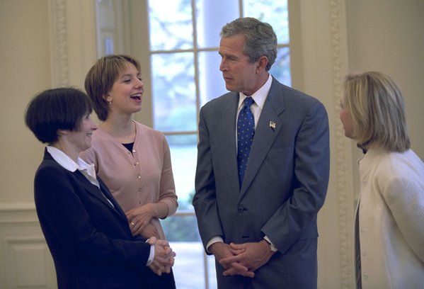 President George W. Bush meets with Sarah Hughes, Olympic gold medalist and figure skater (center, left), her mother, Amy Hughes (far left), and her coach Robin Wagner in the Oval Office Friday, April 12, 2002. White House photo by Eric Draper.