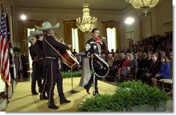 President George W. Bush and Laura Bush listen to Pedro Fernandez perform during a reception honoring Cinco de Mayo in the East Room Friday, May 3. "The victory we commemorate today is a source of tremendous pride to the people of Mexico, and a source of inspiration to the people of America," said the President in his remarks of the celebration that marks Mexico's victory over French occupying forces at the Battle of Puebla in 1862. White House photo by Susan Sterner.
