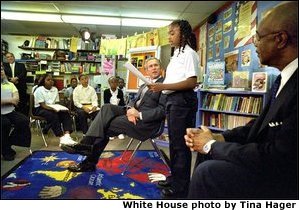 President George W. Bush listens to students read about American values during a visit to Vandenberg Elementary School in Southfield, Mich., Monday, May 6. 