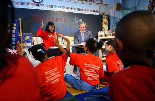 President George W. Bush visits with teacher Carolyn Davis and her students at Clarke Street Elementary School in Milwaukee, Wis., Wednesday, May 8. "I'm here because this is a great school that believes every child can learn," said President Bush who listened to the students demonstrate their reading drills. During his talk with the children, the President emphasized the importance of reading over watching television. 