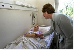 Laura Bush visits a patient in an oncology clinic in Budapest, Hungary, May 17, 2002.  White House photo by Susan Sterner