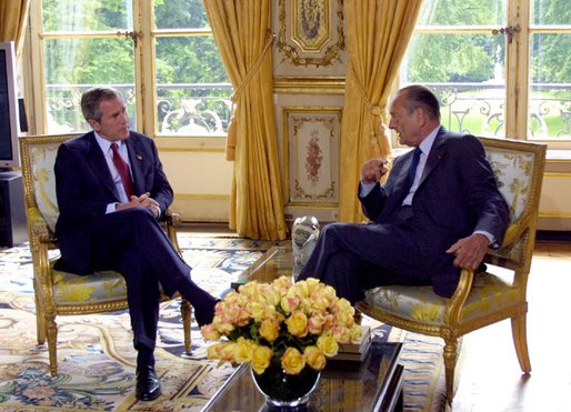President George W. Bush talks with French President Jacques Chirac after arriving at the Elysee Palace in Paris, France on May 26, 2002. White House photo by Paul Morse.