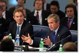President George W. Bush address world leaders with British Prime Minister Tony Blair next to him during the meeting of the NATO-Russia Council at Practica di Mare Air Force base near Rome, Italy on May 28, 2002.