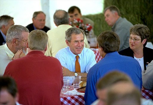 President George W. Bush sits down with families at a barbecue picnic at the 14th Annual World Pork Expo in Des Moines, Iowa. The President’s Job and Growth Plan helps American families by increasing the standard deduction for married couples, raising the Child Tax Credit and eliminating the double taxation of dividends earned by stockholders White House photo by Eric Draper