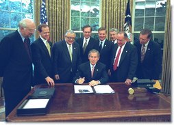 President George W. Bush signs the Export-Import Bank Reauthorization Act in the Oval Office June 14, 2002. White House photo by Paul Morse.