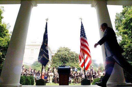 President George W. Bush approaches the podium to unveil his plan for the Middle East during a Rose Garden press conference Monday June 24. White House photo by Eric Draper.