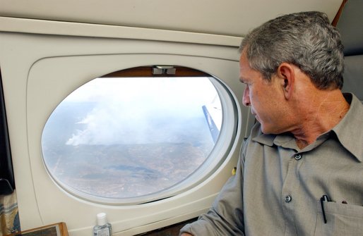 President George W. Bush looks out the window of Air Force One during an aerial tour of the forest fires over Springerville, Ariz., Tuesday, June 25. White House photo by Eric Draper.
