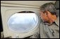 President George W. Bush looks out the window of Air Force One during an aerial tour of the forest fires over Springerville, Ariz., Tuesday, June 25. White House photo by Eric Draper.