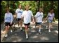 President George W. Bush and First Lady Laura Bush complete a four mile walk with brother Marvin Bush, left, Chief of Staff Andy Card and wife Kathleene after undergoing a colorectal screening procedure at Camp David, Saturday morning, June 29. White House photo by Eric Draper