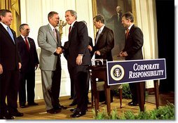 President George W. Bush shakes hands with Sen. Mike Oxley, R-MD, during the signing of the ceremony of the Sarbanes-Oxley Act in the East Room, July 30. "This new law sends very clear messages that all concerned must heed. This law says to every dishonest corporate leader: you will be exposed and punished; the era of low standards and false profits is over; no boardroom in America is above or beyond the law," said the President in his remarks. White House photo by Eric Draper.