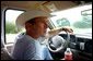 President George W. Bush drives his pickup truck at his ranch in Crawford, Texas, Friday, Aug. 9, 2002. White House photo by Eric Draper.