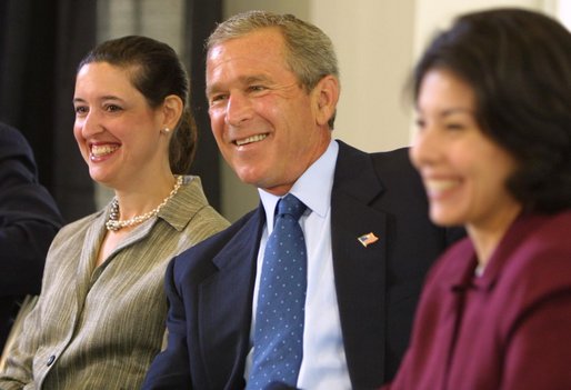 President George W. Bush listens to a suggestion with panelists Carmen Agiuar, left, and Delia Garcia at the Corporate Responsibility discussion panel at the President's Economic Forum held at Baylor University in Waco, Texas on Tuesday August 13, 2002. 