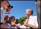 President George W. Bush greets the audience after speaking at the Iowa State Fair Fairgrounds, Wednesday, Aug. 14, 2002. 