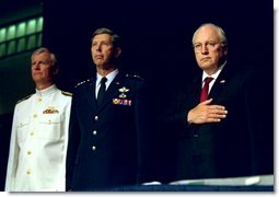 Vice President Dick Cheney Vice stands at attention with Vice Admiral John Totushek, left, and General Donald Cook, center, during the National Anthem moments before addressing veterans of the Korean War in San Antonio, TX Aug. 29, 2002. White House photo by David Bohrer.