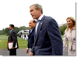 Flanked by interpreters, President George W. Bush and Italian Prime Minister Silvio Berlusconi leave a news conference after Berlusconi's arrival at Camp David, Saturday, Sept. 14, 2002. WHITE HOUSE PHOTO BY ERIC DRAPER White House photo by Eric Draper.