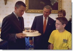 President George W. Bush and Matthew Skowronski, 13, a leukemia survivor, (right), admire the cake Lance Armstrong was given by the White House in honor of his 31st birthday. Armstrong, a cancer survivor and 4-time winner of the Tour De France, spoke Wednesday, Sept. 18, to encourage and support new cancer survivorship initiatives and legislation. White House photo by Paul Morse.