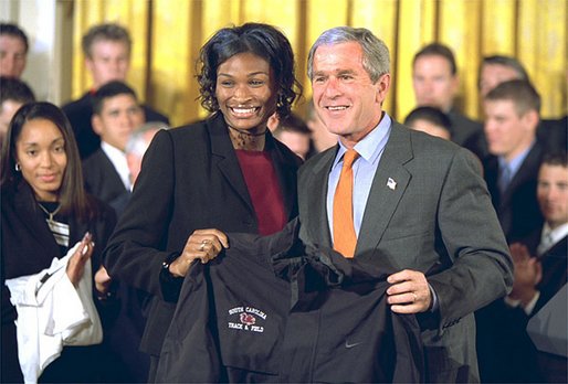 President George W. Bush receives a jersey from the captain of University of South Carolina Women's Track & Field team at the White House Tuesday, Sept. 24. White House photo by Paul Morse.