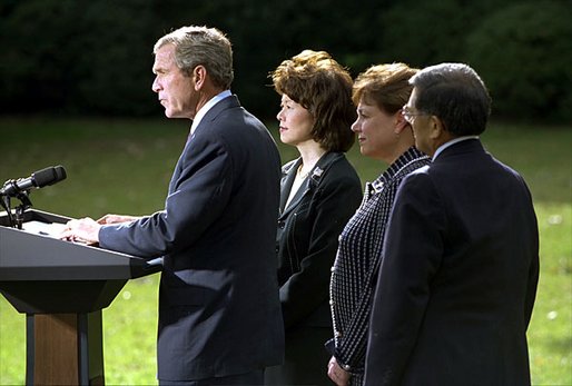 President George W. Bush discusses his decision to seek an injunction under the Taft-Hartley Act to stop the lockouts of America's western ports during a press conference on the South Lawn of the White House Tuesday, Oct. 8. Accompanying the President is Secretaries Elaine Chao, left, Ann Veneman, center, and Norm Mineta. White House photo by Tina Hager.