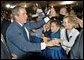 President George W. Bush greets audience members after speaking during the Colorado Welcome at the Wings Over The Rockies Air and Space Museum in Denver, Colo., Monday, Oct. 28. 