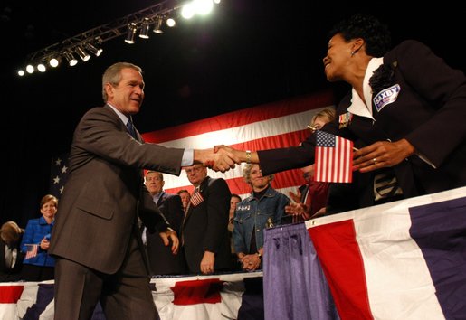 President George W. Bush greets stage participants during the Atlanta, Georgia Welcome at the Cobb Galleria Centre, Saturday, Nov. 2, 2002. White House photo by Eric Draper.