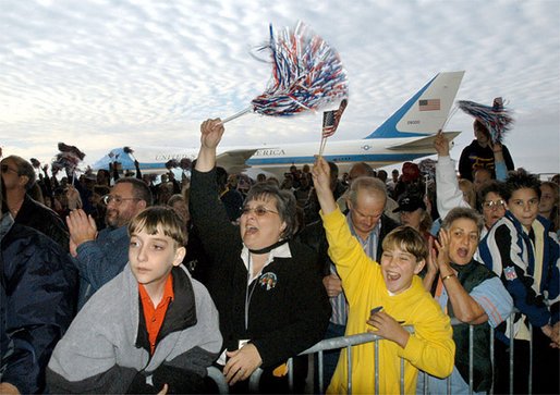 Air Force One stands at the ready for President George W. Bush as a crowd cheers while the aircraft's chief passenger speaks during the Arkansas Welcome at the Northwest Arkansas Regional Airport, Monday, Nov. 4. White House photo by Eric Draper.