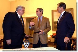 President George W. Bush talks with House Speaker Dennis Hastert and Senate Republican Leader Trent Lott while watching election returns in the White House residence Tuesday night, Nov. 5, 2002.  White House photo by Eric Draper