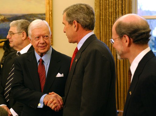 President George W. Bush greets former President Jimmy Carter during a photo opportunity in the Oval Office with the Nobel Laureates Monday, Nov.18. "These Americans are a great honor to their fields and a great honor to our country. And we're proud to have you here. We're proud for what you've done, for not only America but the world. And we're proud for your contributions," said President Bush. White House photo by Tina Hager.