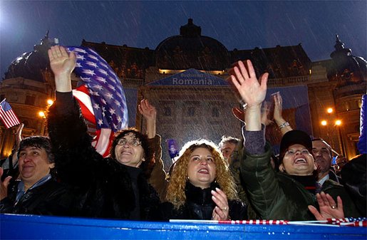 Braving a cold rain, thousands of Romanian citizens came to Revolution Square to hear President Bush speak Nov. 23. "I know that your hardship did not end with your oppression. America respects your labor, your patience, your daily determination to find a better life. Your effort has been recognized by an offer to NATO membership. We welcome Romania into NATO," said President Bush. White House photo by Paul Morse.