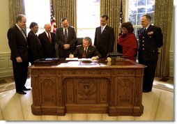 President George W. Bush signs the Maritime Transportation Security Act of 2002 in the Oval Office, Nov. 25, 2002.  White House photo by Paul Morse