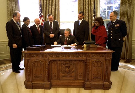 President George W. Bush signs the Maritime Transportation Security Act of 2002 in the Oval Office, Nov. 25, 2002. White House photo by Paul Morse.