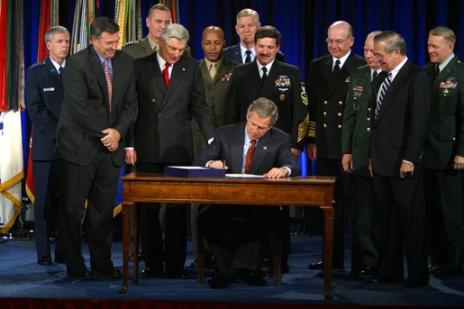 President George W. Bush signs the Bob Stump National Defense Authorization Act at the Pentagon Monday, Dec 2. "The legislation I sign this afternoon was passed by Congress in a remarkable spirit of unity. It sets priorities of our Defense Department in a critical, critical period for our country," said President Bush."We're rewarding the service and sacrifice of our military families with higher pay, improved facilities and better housing." White House photo by Paul Morse