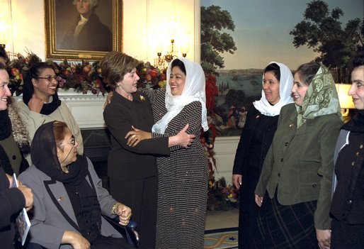 Afghani teacher Rayhaanah of Kabul embraces Laura Bush during a visit of 13 Afghani women teachers to the White House Wednesday, December 4, 2002. The teachers are concluding a six-week training program in the United States to help them become master teachers and teacher trainers upon return to Afghanistan. White House photo by Susan Sterner