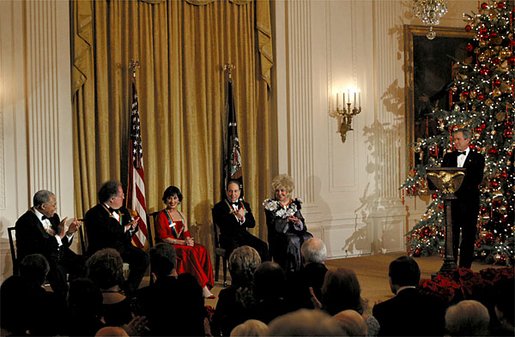 President George W. Bush welcomes the recipients of the Kennedy Center Honors of 2002 to the White House Sunday, Dec. 8. Each year The John F. Kennedy Center for the Performing Arts honors a select number of artists for lifetime achievements and their influence upon American culture. From left to right, the recipients are actor James Earl Jones; conductor James Levine; dancer and actress Chita Rivera; singer Paul Simon and actress Elizabeth Taylor. White House photo by Susan Sterner.