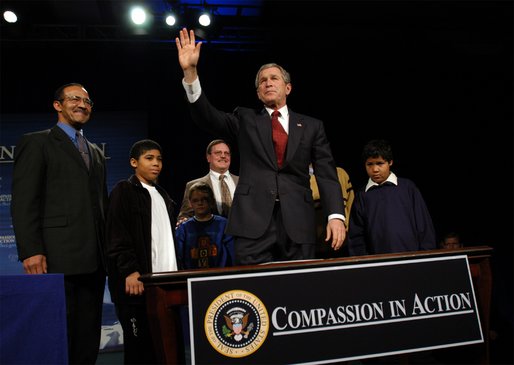 President George W. Bush waves to the audience after signing an executive order for equal protection of the laws for faith-based and community organizations in Philadelphia, Pa., Thursday, Dec. 12. White House photo by Eric Draper