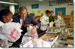 President George W. Bush and Laura Bush help volunteers pack food during their visit to the Capital Area Food Bank in Washington, D.C., Thursday, Dec. 19. "More Americans need to volunteer. There are ways to do so. The USAFreedomCorps.gov on the web page is the place to look," said the President in his remarks. "You can call 1-877-USA-CORPS and find out ways that you can help. If you are interested in being a part of feeding those who hunger, this is a great place to come to."  White House photo by Tina Hager