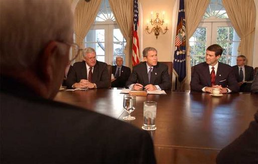 President George W. Bush signs the Temporary Extended Unemployment Compensation Act of 2002 in the Cabinet Room, Tuesday, Jan 7, 2003. Seated with the President are Sen. Bill Frist, right, Senate Majority Leader, and Congressman Dennis Hastert, left, Speaker of the House. The bill extends a federal program to provide 13 weeks of benefits for the unemployed who have exhausted their 26 weeks of state unemployment. White House photo by Tina Hager