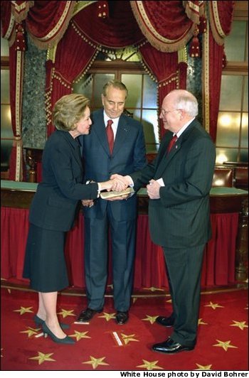 In his role as President of the Senate, Vice President Dick Cheney presides over the swearing in of 35 new senators as part of the opening of the 108th Congress Tuesday Jan. 7, 2003. Here, the Vice President congratulates newly-elected Senator Elizabeth Dole, R-N.C., in the Old Senate Chamber of the Capitol as her husband, former Senator Bob Dole, looks on. White House photo by David Bohrer