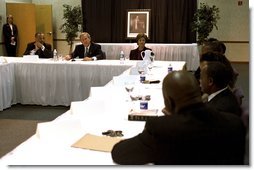 Celebrating the national observance of Dr. Martin Luther King, Jr.'s birthday, President George W. Bush, Laura Bush and Pastor John K. Jenkins, Sr., far left, take part in a roundtable discussion with congregation members and community leaders at the First Baptist Church of Glenarden in Landover, Md., Jan. 20, 2003. "It is fitting we meet here in a church because in this society, we must understand government can help, government can write checks -- but it cannot put hope in people's hearts or a sense of purpose in people's lives," said the President in his remarks.  White House photo by Susan Sterner