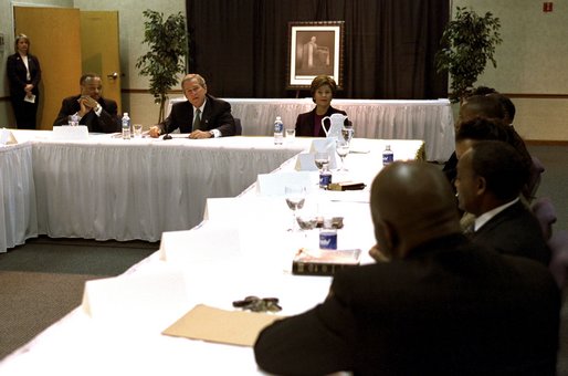 Celebrating the national observance of Dr. Martin Luther King, Jr.'s birthday, President George W. Bush, Laura Bush and Pastor John K. Jenkins, Sr., far left, take part in a roundtable discussion with congregation members and community leaders at the First Baptist Church of Glenarden in Landover, Md., Jan. 20, 2003. "It is fitting we meet here in a church because in this society, we must understand government can help, government can write checks -- but it cannot put hope in people's hearts or a sense of purpose in people's lives," said the President in his remarks. White House photo by Susan Sterner.
