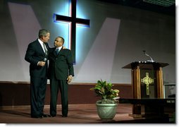 President George W. Bush embraces Pastor John K. Jenkins, Sr. of the First Baptist Church of Glenarden during an annual service honoring Dr. Martin Luther King, Jr. in Landover, Md., Monday, Jan. 20, 2003. "And even though progress has been made, Pastor -- even though progress has been made, there is more to do," said the President in his remarks. "There are still people in our society who hurt. There is still prejudice holding people back. There is still a school system that doesn't elevate every child so they can learn."  White House photo by Susan Sterner