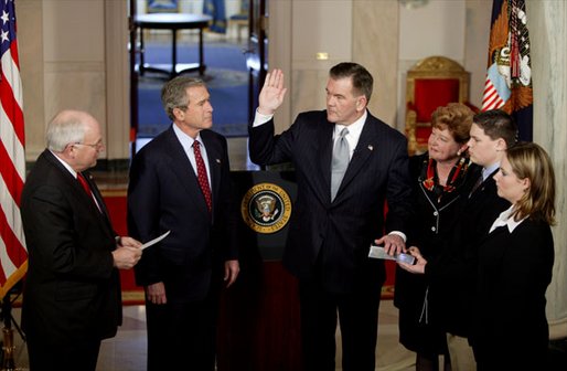 As President George W. Bush watches, Vice President Dick Cheney swears in Tom Ridge as the Secretary of the Department of Homeland Security in the Cross Hall Jan. 24, 2003. Secretary Ridge's wife, Michele, and children, Tom and Lesley, hold the Bible during the administering of the oath. "In October of 2001, when I established the office -- the White House Office of Homeland Security -- I knew immediately that Tom was the right man for the assignment. He's a decisive, clear-thinking executive who knows how to solve problems. He's a person of integrity and a person of good judgment," said the President in his remarks. White House photo by Paul Morse