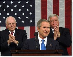 President George W. Bush reacts to applause while delivering the State of the Union address at the U.S. Capitol, Tuesday, Jan. 28, 2003. Also pictured are Vice President Dick Cheney, left, and Speaker of the House Dennis Hastert.  White House photo by Eric Draper