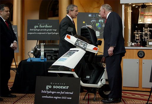President George W. Bush looks over a scooter powered by solid hydrogen fuel during a demonstration of energy technologies at The National Building Museum in Washington, D.C., Thursday, Feb. 6, 2003. "Cars that will run on hydrogen fuel produce only water, not exhaust fumes," said the President in his remarks. "If we develop hydrogen power to its full potential, we can reduce our demand for oil by over 11 million barrels per day by the year 2040." White House photo by Paul Morse.