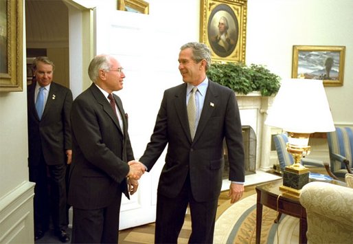President George W. Bush welcomes Australian Prime Minister John Howard to the Oval Office Monday, Feb. 10, 2003. After meeting privately, the two leaders held a joint press conference in which they discussed disarmament in Iraq. White House photo by Paul Morse