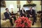 President George W. Bush meets with Yasar Yakis, Foreign Minister of Turkey, center, and Ali Babacan, Minister of State for the Economy of Turkey, in the Oval Office Friday, Feb. 14, 2003. White House photo by Tina Hager