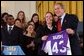 Valerie Fletcher, captain of the women's soccer team at University of Portland, gives President George W. Bush a team jersey during a visit by the NCAA Fall Champions in the East Room Monday, Feb. 24, 2003. White House photo by Tina Hager