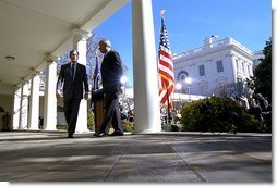 President George W. Bush and Secretary of State Colin Powell walk back to the Oval Office after addressing the media in the Rose Garden Friday, March 14, 2003. The President discussed an outline for peace in the Middle East.  White House photo by Paul Morse