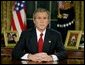 President George W. Bush addresses the nation from theOval Officeat the White HouseWednesday evening, March 19, 2003.   White House photo by Paul Morse