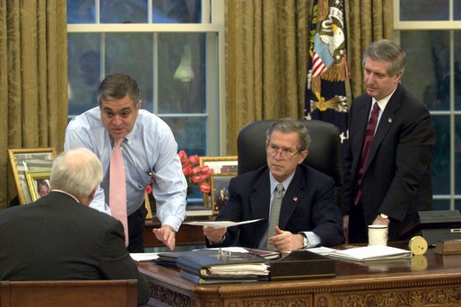 President George W. Bush receives an update on the status of military action in Iraq Thursday morning, March 20, 2003, in the Oval Office. Present are Vice President Dick Cheney, CIA Director George Tenet and Chief of Staff Andy Card. White House photo by Eric Draper