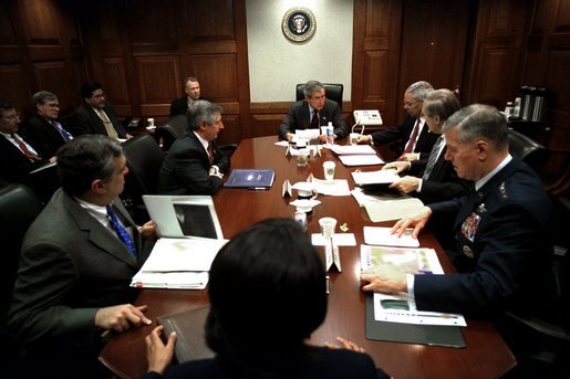 On Friday morning, March 21, 2003, President George W. Bush meets with his war council in the Situation Room of the White House. Present at the table are, from foreground, National Security Advisor Condoleezza Rice, CIA Director George Tenet, Chief of Staff Andy Card, Secretary of State Colin Powell, Secretary of Defense Donald Rumsfeld and Chairman of the Joint Chiefs of Staff Richard B. Myers. White House photo by Eric Draper